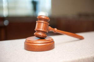 A brown wooden gavel on a table