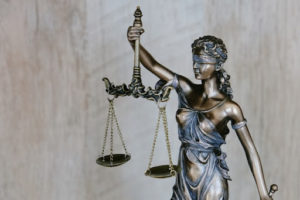 Closeup photo of a lady justice statue in a courtroom