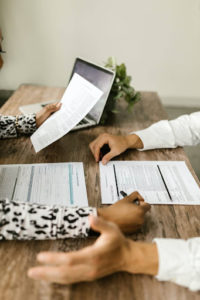 Close-up of insurance policy documents being examined by an attorney and client