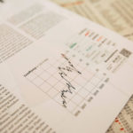 Close-up of financial documents showing investment performance metrics