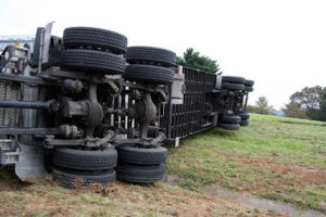 A Semi truck overturned on the side of the road 