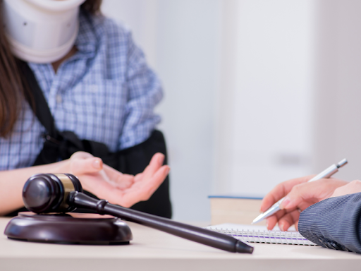 An injured woman meeting with an attorney to discuss compensatory damages 