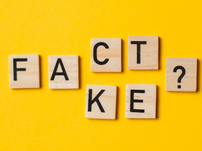 Letter tiles spelling out the words “fact” and “fake,” referencing the myths and misconceptions about class action lawsuits