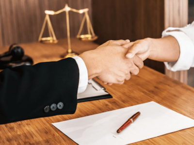 A class action lawyer shaking hands with a new client