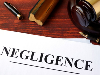 Negligence types out on a white piece of paper on a lawyer’s desk