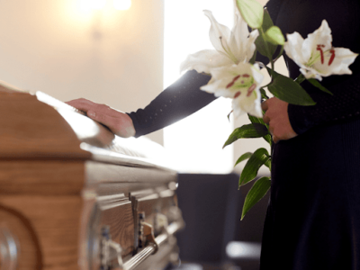 A mourner paying their respects at a funeral