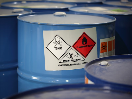 Many blue drums filled with toxic chemicals hazardous to the environment