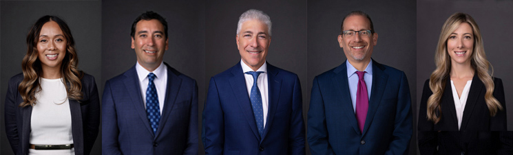 Five professional headshots of three men in suits and ties and two women in professional attire arranged in a row against a dark gray background.